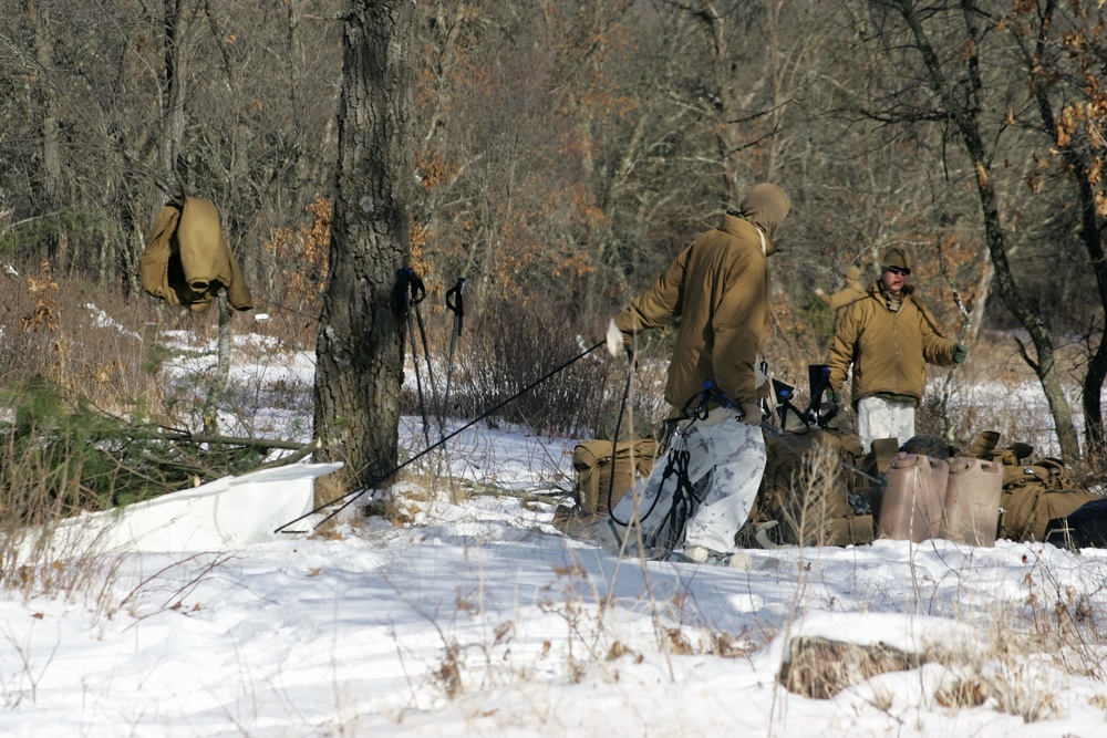 Cold-Weather Operations Course Class 18-04 students build improvised shelters during training at Fort McCoy