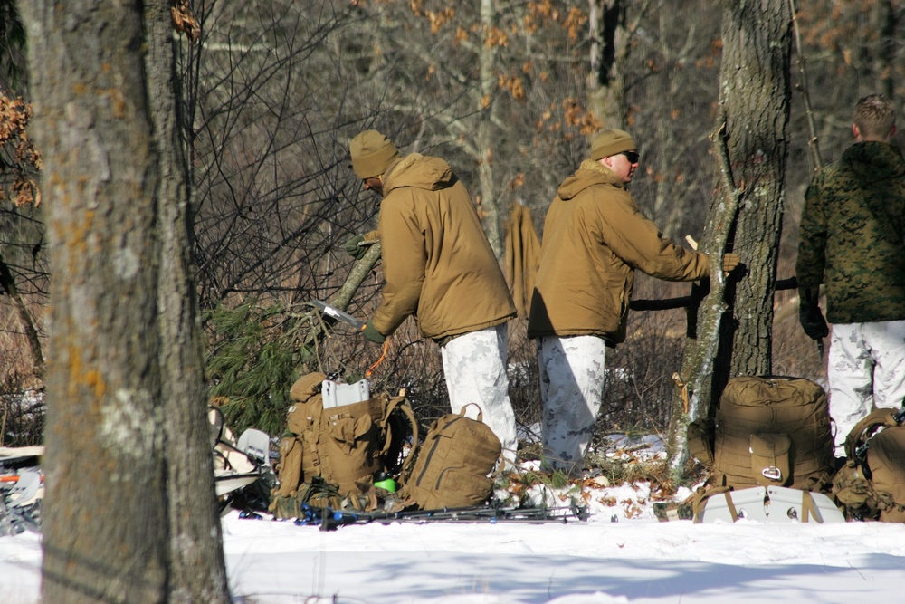 Cold-Weather Operations Course Class 18-04 students build improvised shelters during training at Fort McCoy