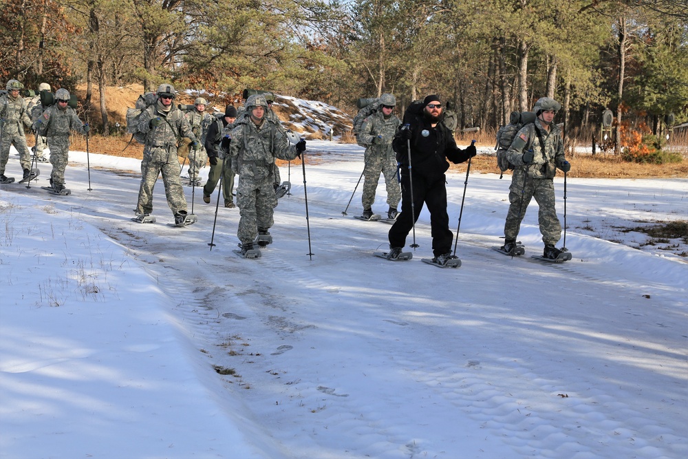 Cold-Weather Operations Course Class 18-05 students practice snowshoeing at Fort McCoy