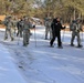 Cold-Weather Operations Course Class 18-05 students practice snowshoeing at Fort McCoy