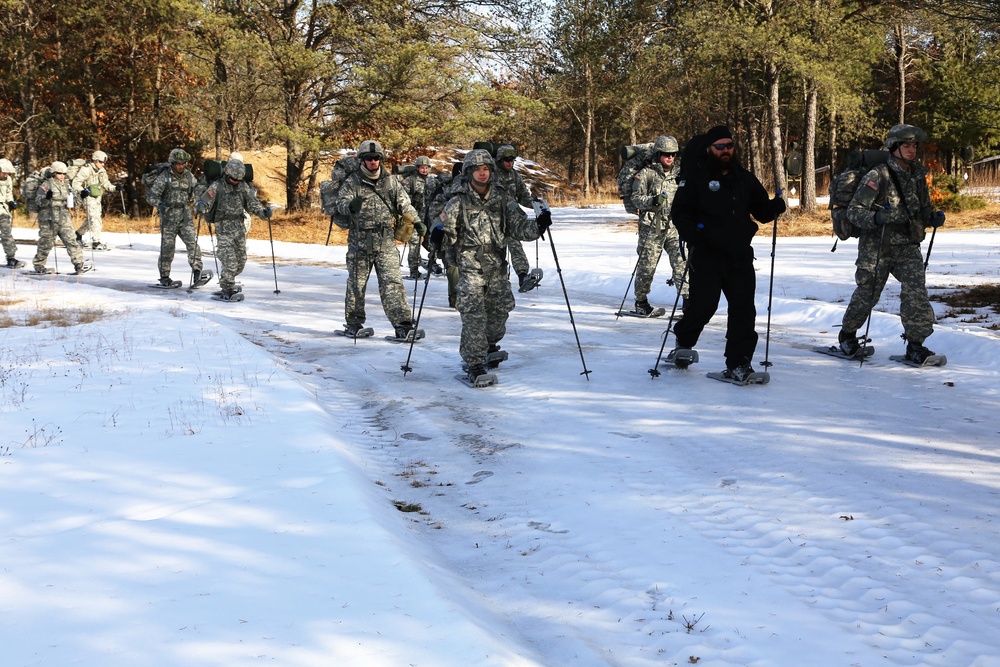 Cold-Weather Operations Course Class 18-05 students practice snowshoeing at Fort McCoy