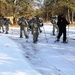 Cold-Weather Operations Course Class 18-05 students practice snowshoeing at Fort McCoy