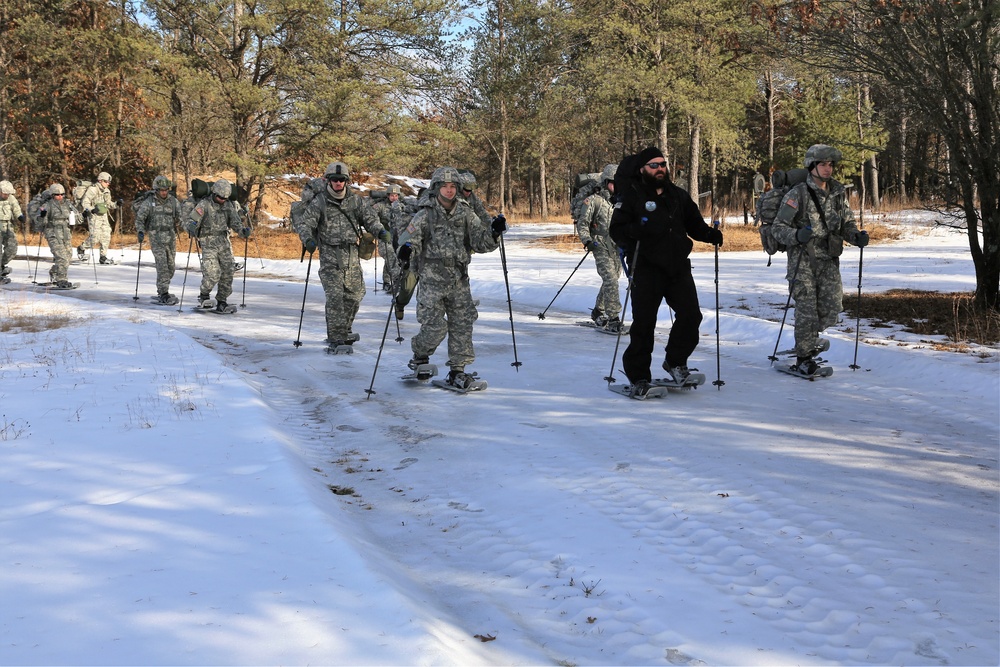 Cold-Weather Operations Course Class 18-05 students practice snowshoeing at Fort McCoy