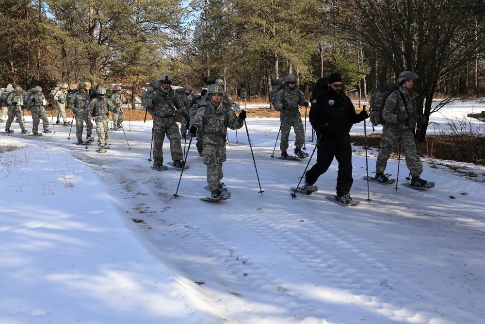 Cold-Weather Operations Course Class 18-05 students practice snowshoeing at Fort McCoy