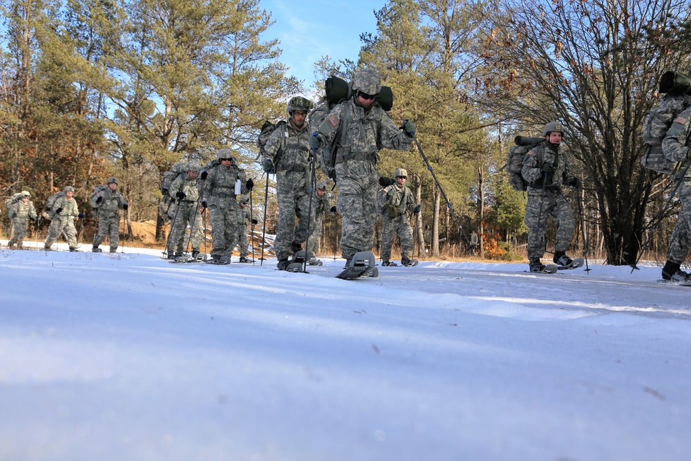 Cold-Weather Operations Course Class 18-05 students practice snowshoeing at Fort McCoy