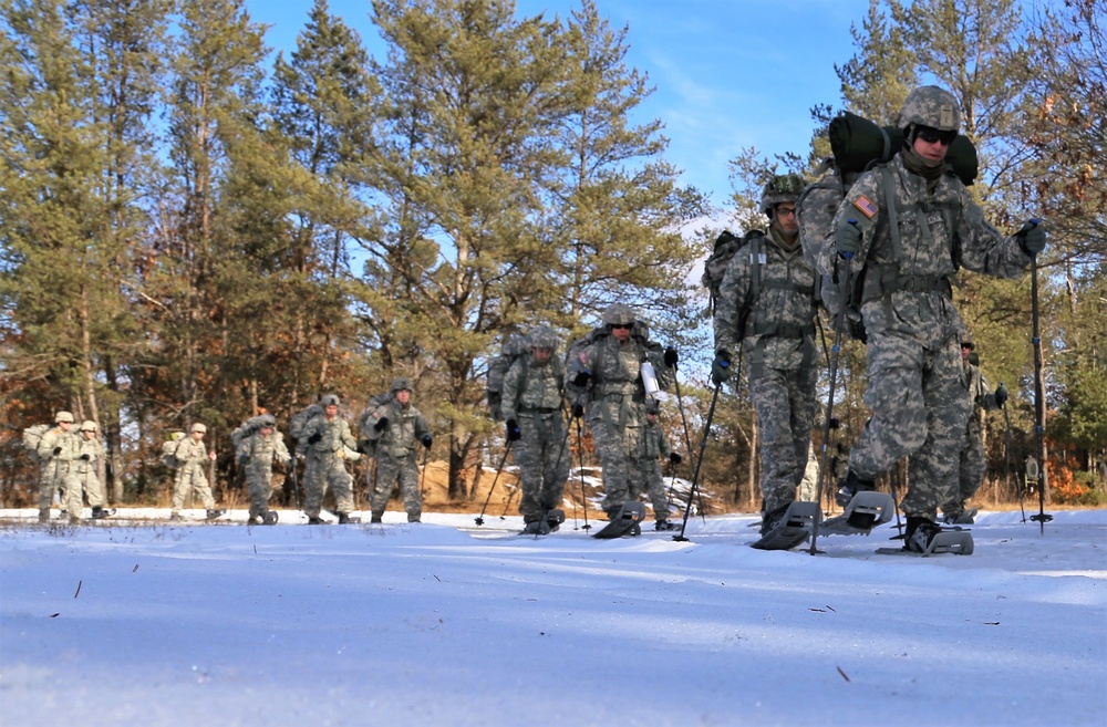 Cold-Weather Operations Course Class 18-05 students practice snowshoeing at Fort McCoy