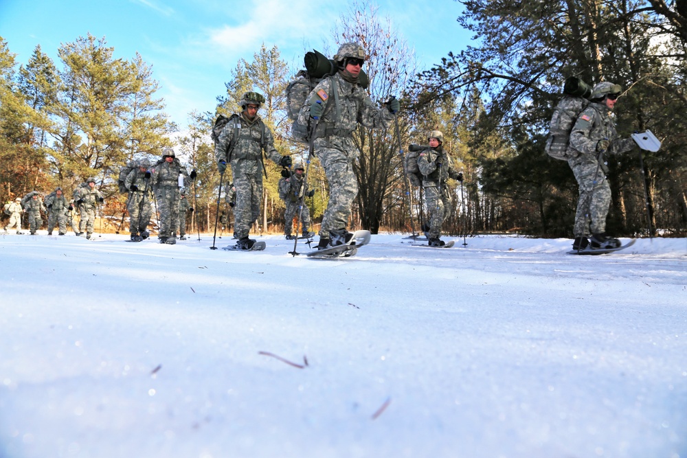 Cold-Weather Operations Course Class 18-05 students practice snowshoeing at Fort McCoy