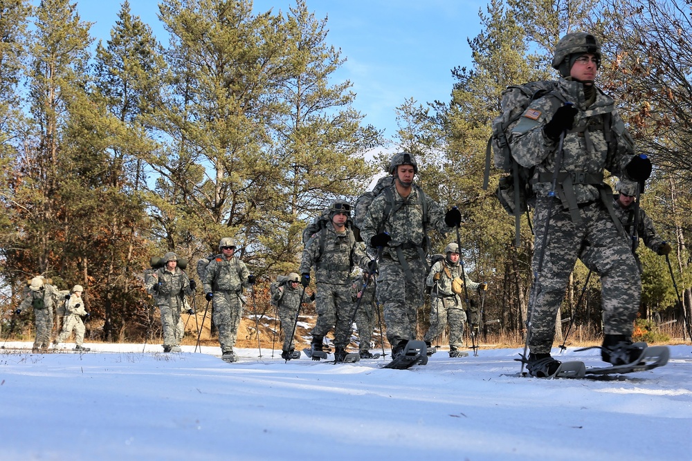 Cold-Weather Operations Course Class 18-05 students practice snowshoeing at Fort McCoy