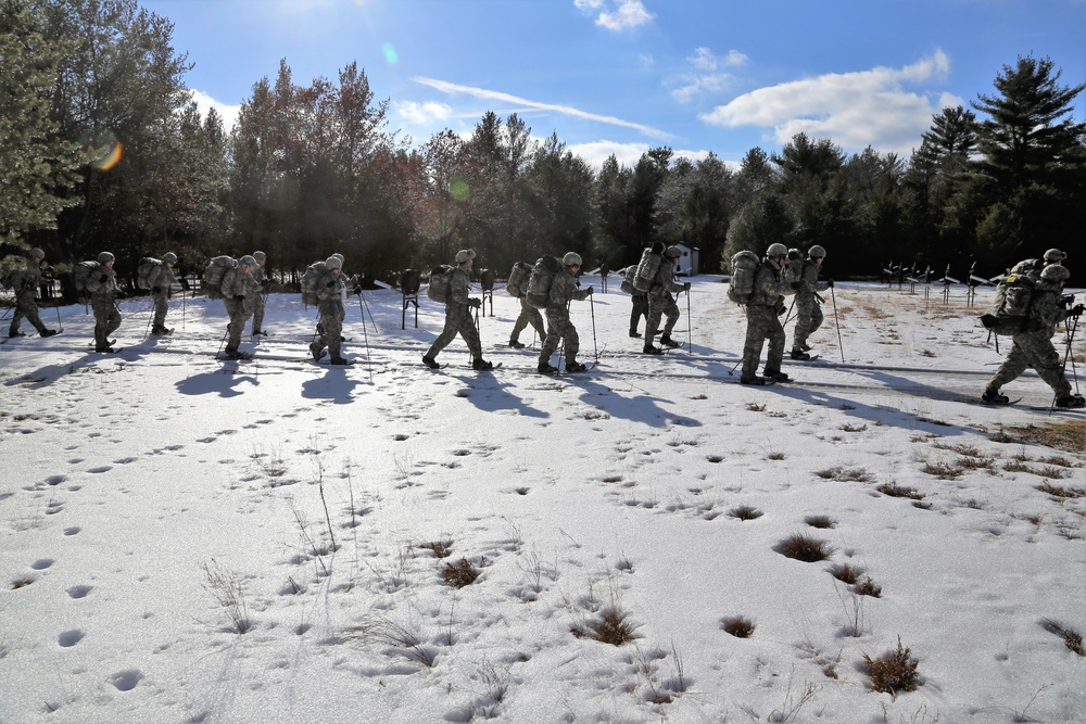 Cold-Weather Operations Course Class 18-05 students practice snowshoeing at Fort McCoy