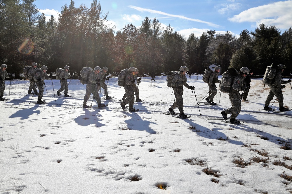 Cold-Weather Operations Course Class 18-05 students practice snowshoeing at Fort McCoy