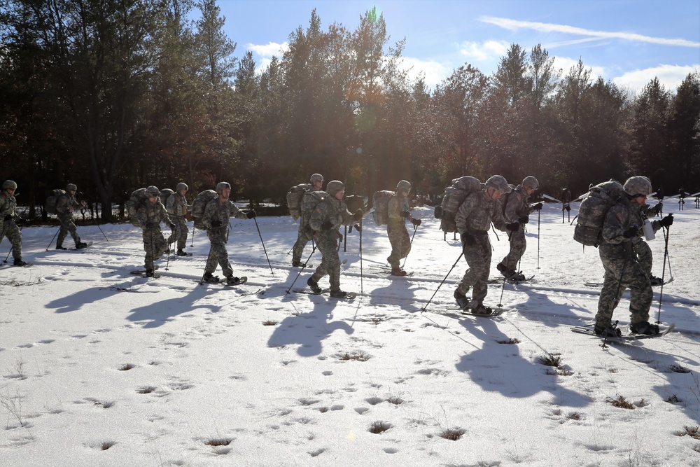 Cold-Weather Operations Course Class 18-05 students practice snowshoeing at Fort McCoy