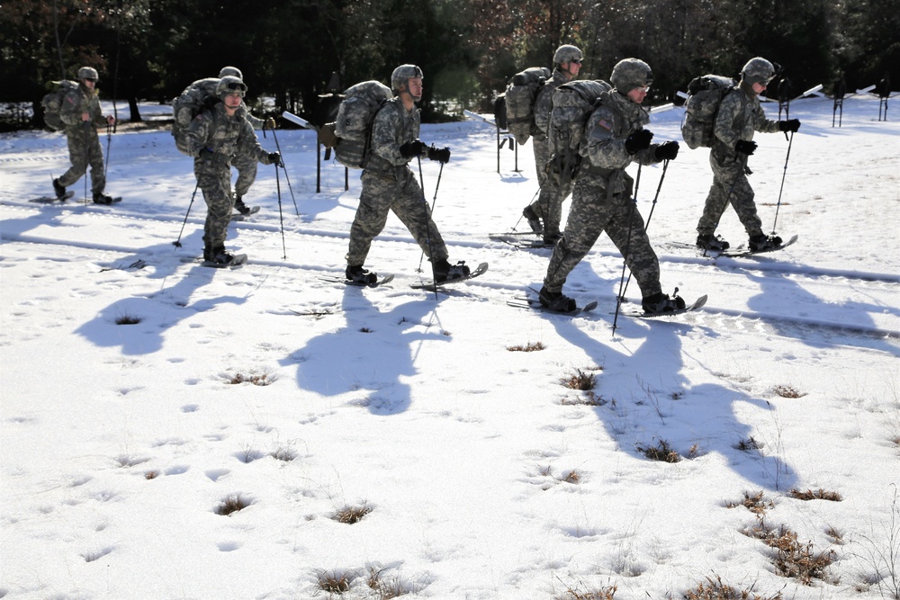 Cold-Weather Operations Course Class 18-05 students practice snowshoeing at Fort McCoy