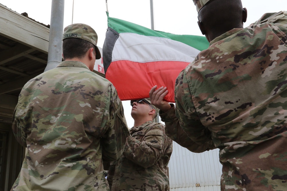 U.S. Soldiers replace Kuwaiti flag over Camp Patriot before Liberation Day