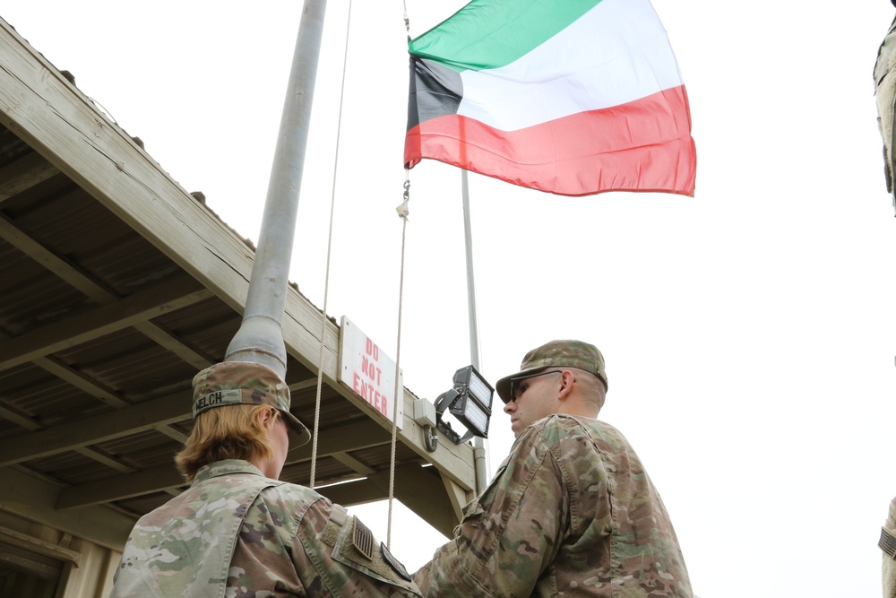 U.S. Soldiers replace Kuwaiti flag over Camp Patriot before Liberation Day