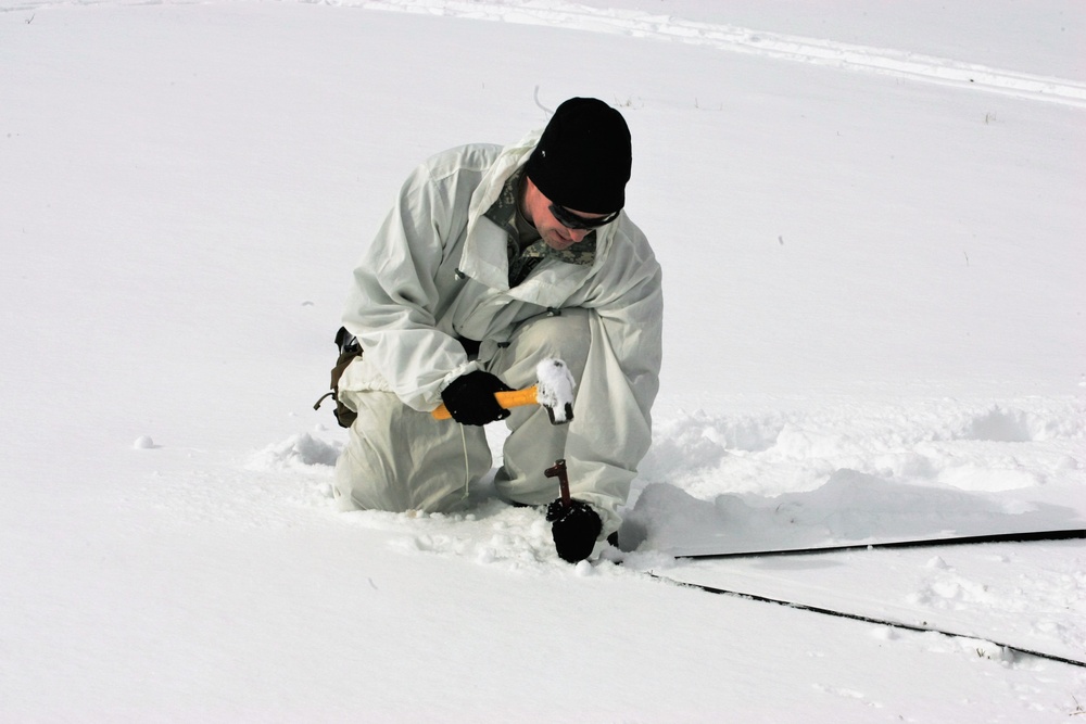Cold-Weather Operations Course Class 18-06 students build Arctic tents during training at Fort McCoy