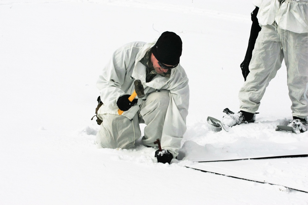 Cold-Weather Operations Course Class 18-06 students build Arctic tents during training at Fort McCoy