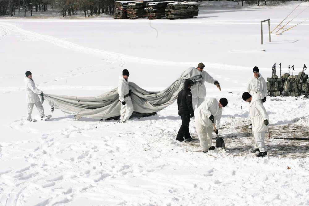 Cold-Weather Operations Course Class 18-06 students build Arctic tents during training at Fort McCoy