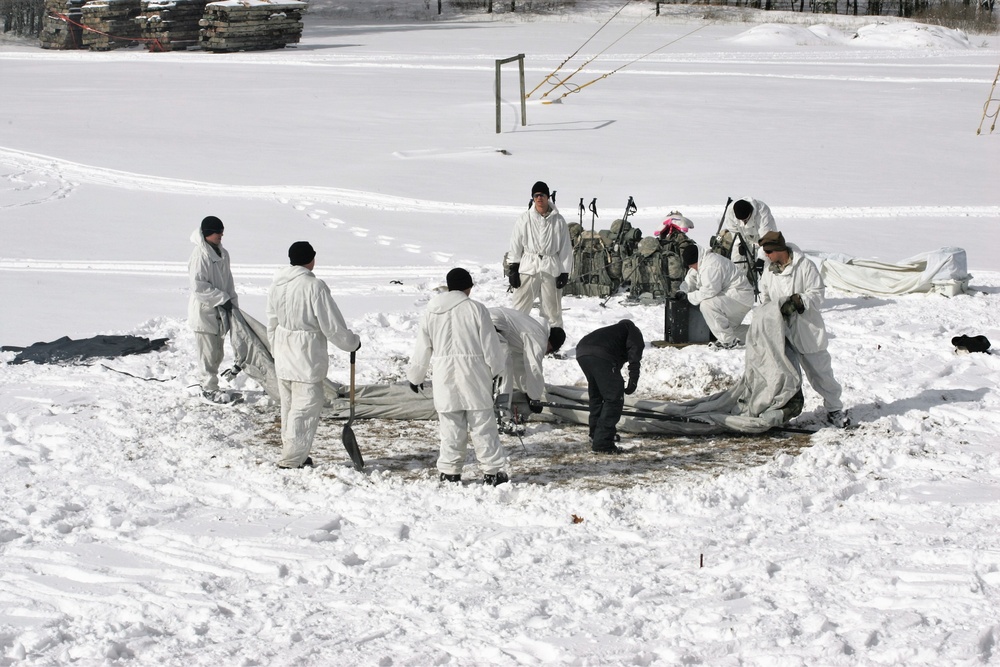 Cold-Weather Operations Course Class 18-06 students build Arctic tents during training at Fort McCoy