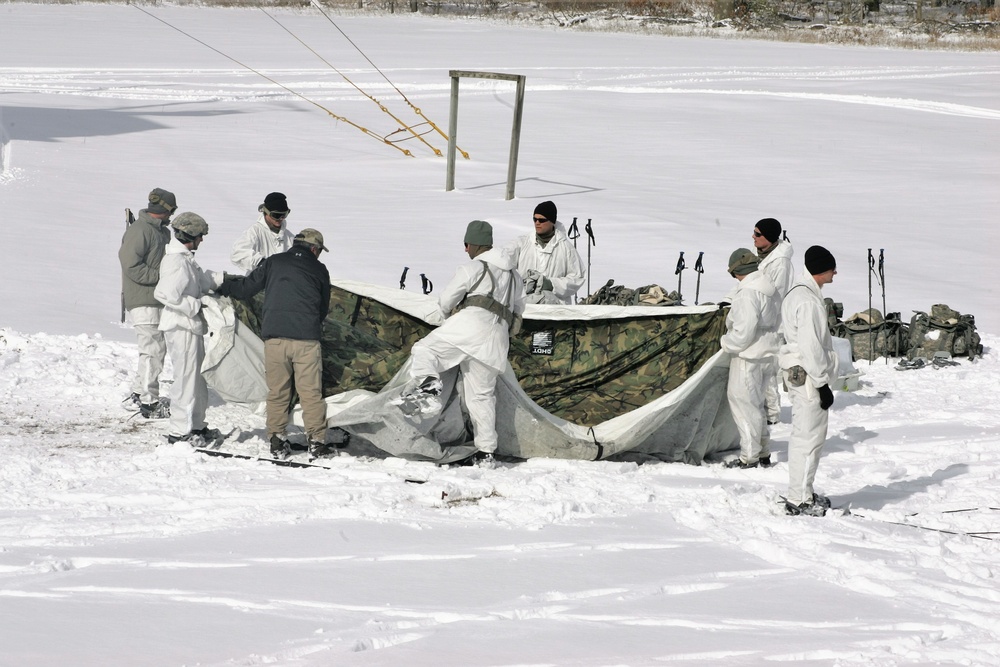 Cold-Weather Operations Course Class 18-06 students build Arctic tents during training at Fort McCoy