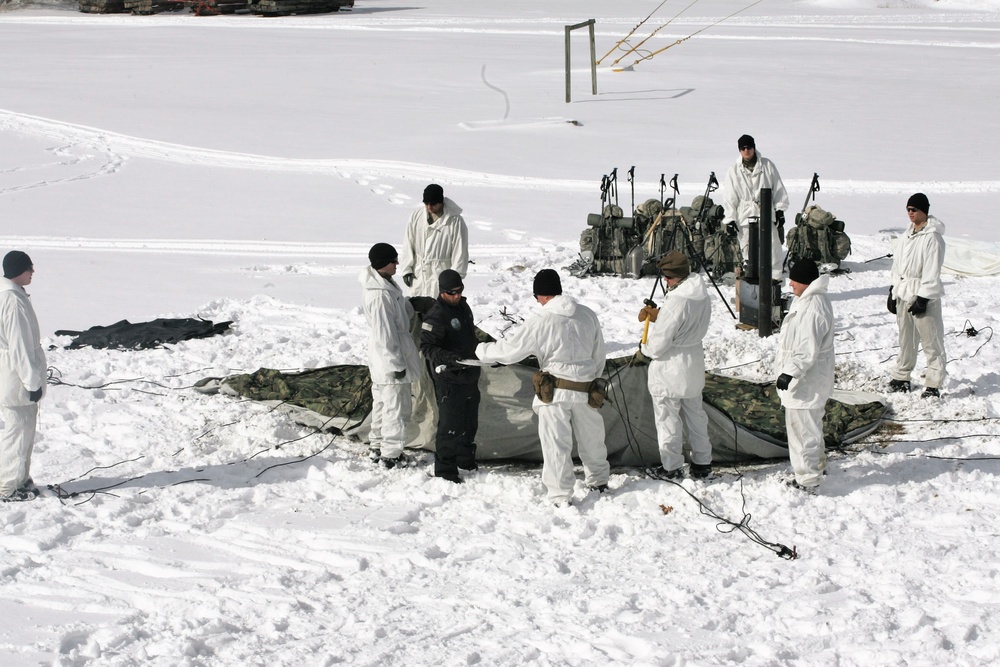 Cold-Weather Operations Course Class 18-06 students build Arctic tents during training at Fort McCoy