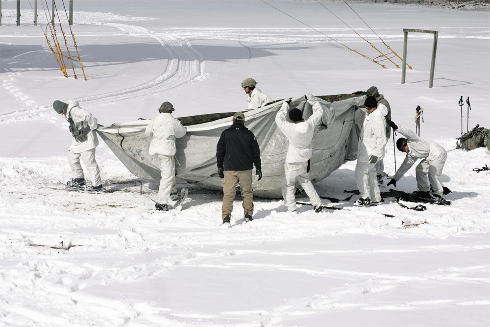 Cold-Weather Operations Course Class 18-06 students build Arctic tents during training at Fort McCoy
