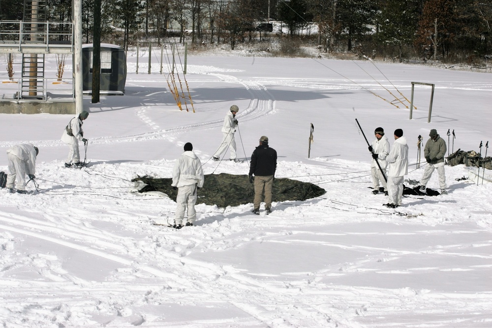 Cold-Weather Operations Course Class 18-06 students build Arctic tents during training at Fort McCoy