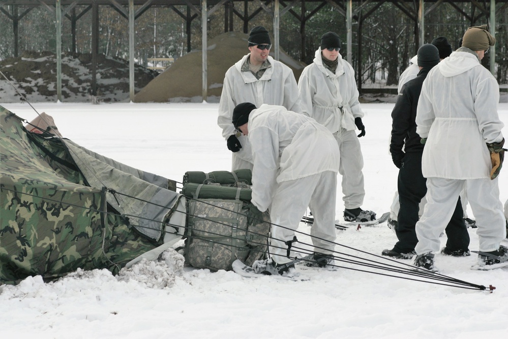 Cold-Weather Operations Course Class 18-06 students build Arctic tents during training at Fort McCoy