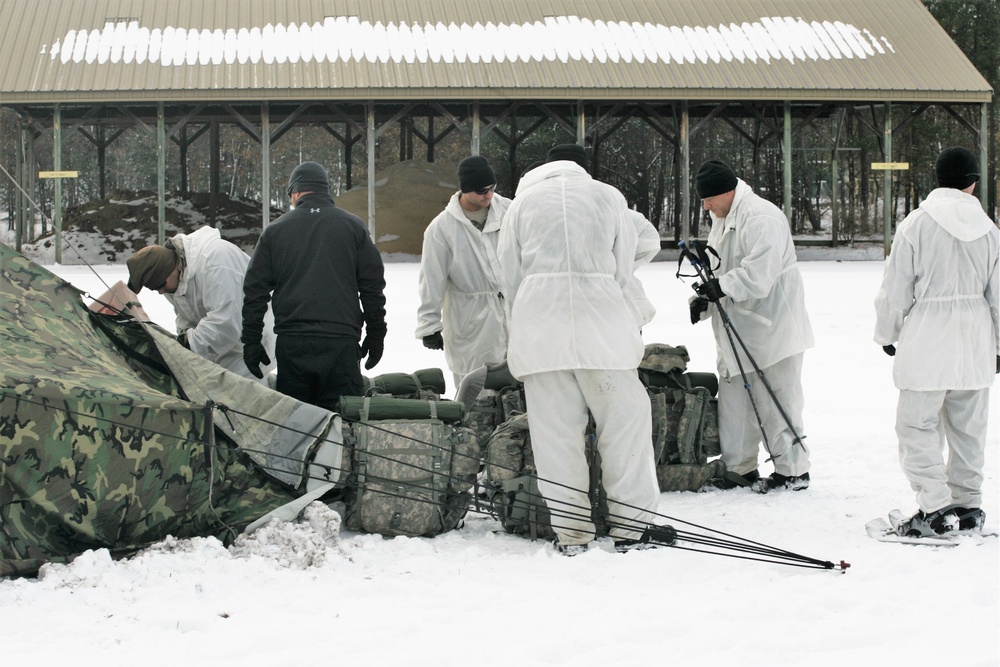 Cold-Weather Operations Course Class 18-06 students build Arctic tents during training at Fort McCoy
