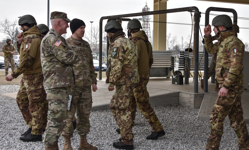 Italian paratroopers exit past USARAF Commander