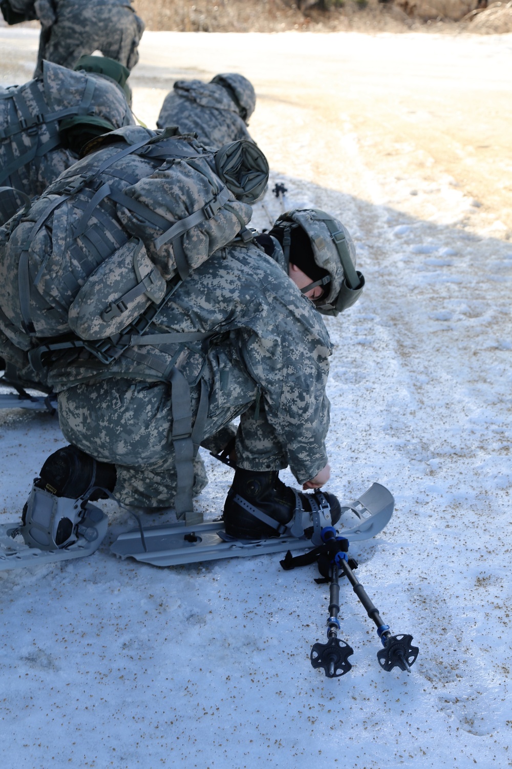 Cold-Weather Operations Course Class 18-05 students practice snowshoeing at Fort McCoy