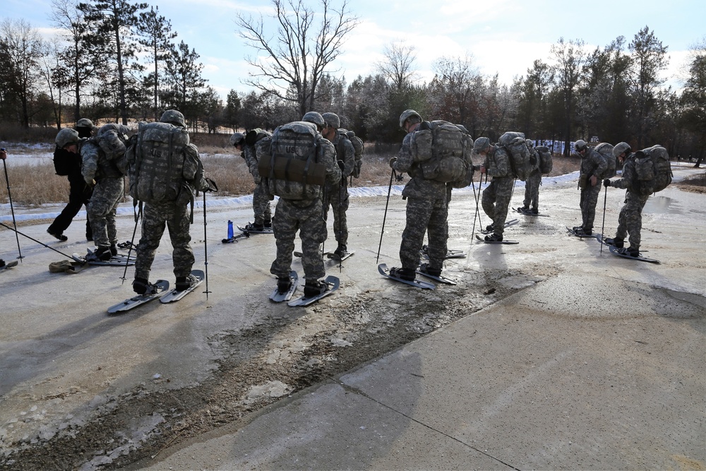 Cold-Weather Operations Course Class 18-05 students practice snowshoeing at Fort McCoy