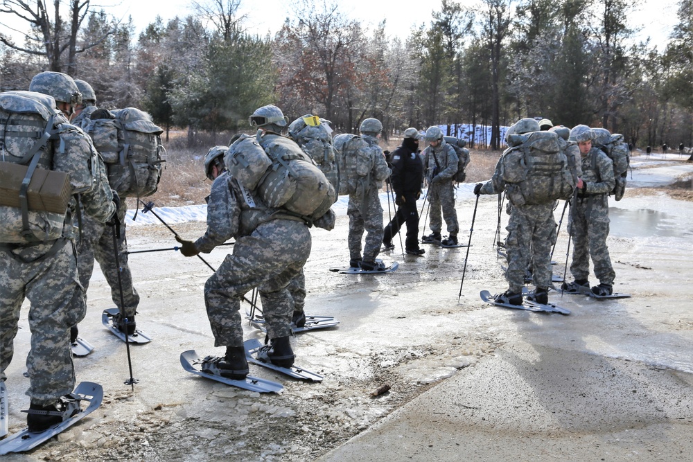 Cold-Weather Operations Course Class 18-05 students practice snowshoeing at Fort McCoy