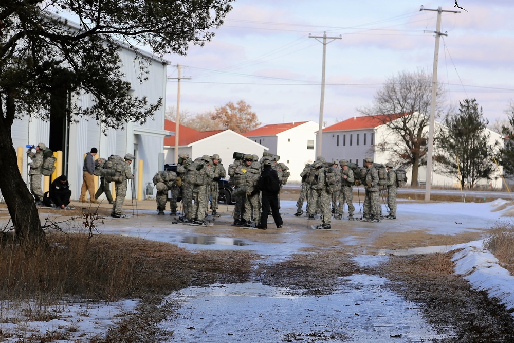 Cold-Weather Operations Course Class 18-05 students practice snowshoeing at Fort McCoy