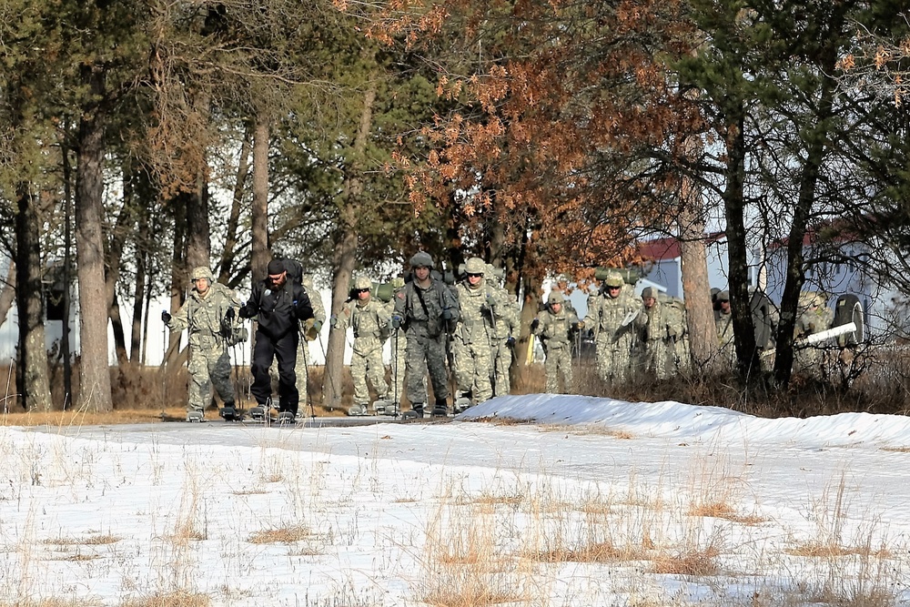 Cold-Weather Operations Course Class 18-05 students practice snowshoeing at Fort McCoy