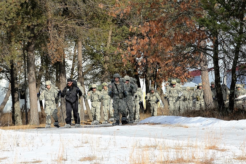 Cold-Weather Operations Course Class 18-05 students practice snowshoeing at Fort McCoy