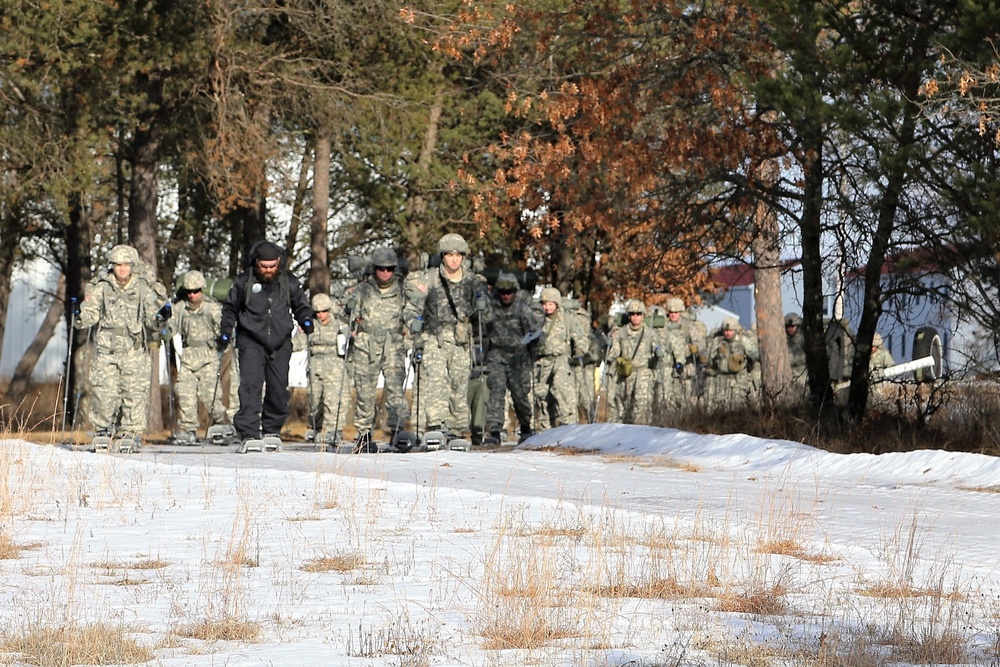 Cold-Weather Operations Course Class 18-05 students practice snowshoeing at Fort McCoy