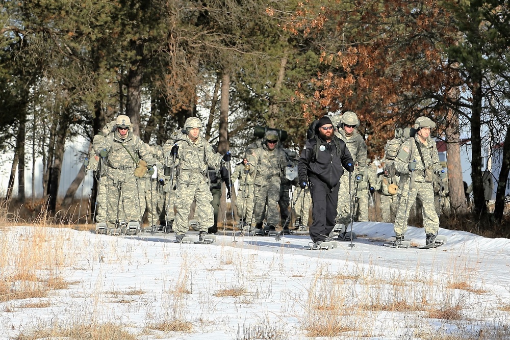 Cold-Weather Operations Course Class 18-05 students practice snowshoeing at Fort McCoy