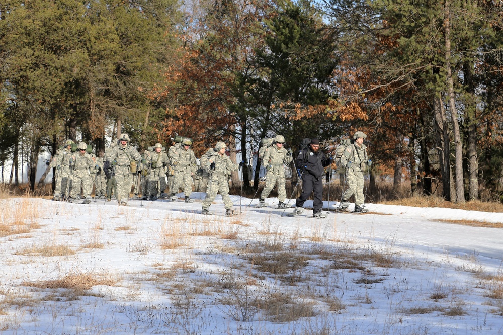 Cold-Weather Operations Course Class 18-05 students practice snowshoeing at Fort McCoy