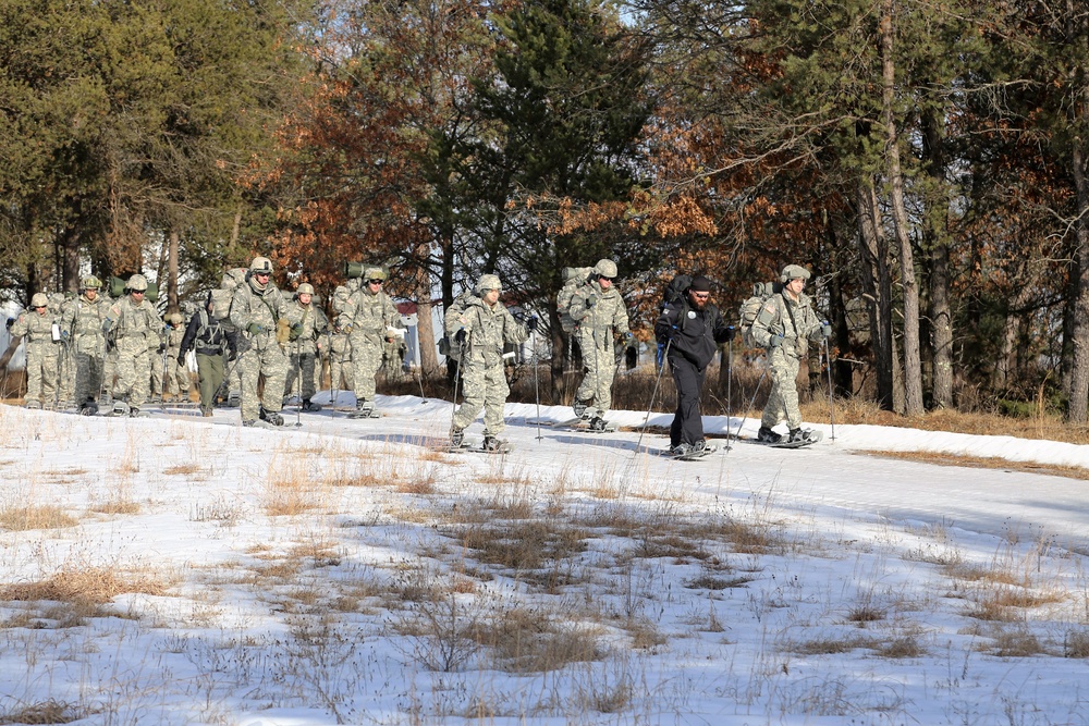 Cold-Weather Operations Course Class 18-05 students practice snowshoeing at Fort McCoy