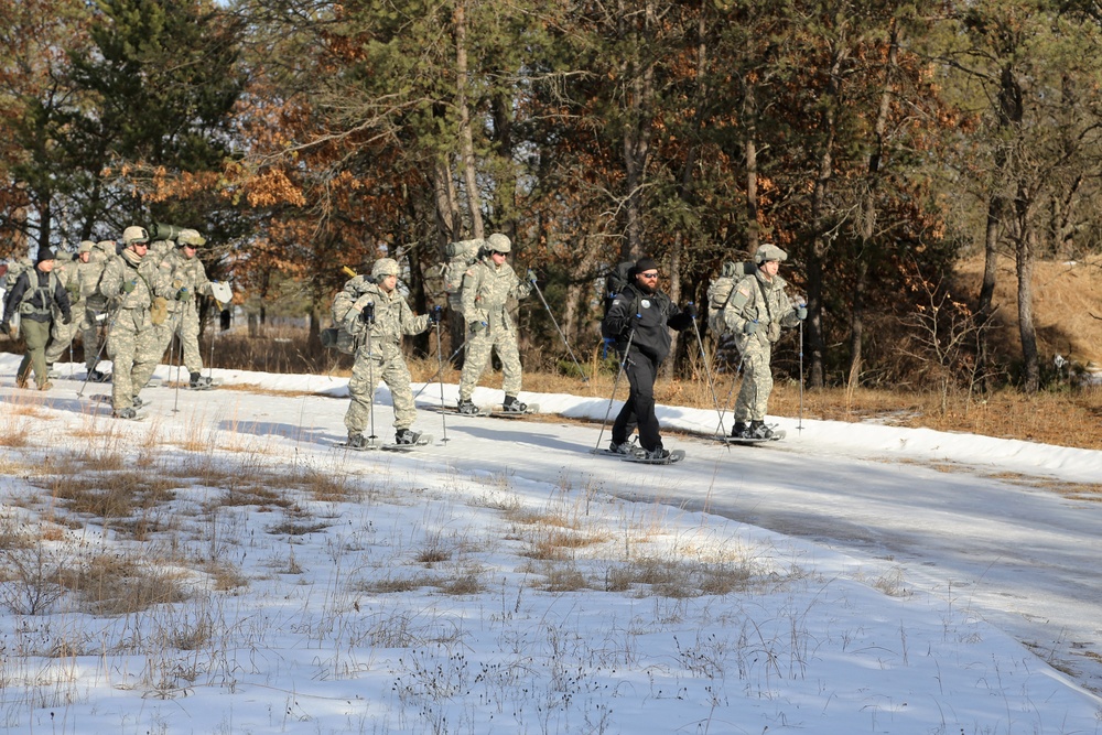 Cold-Weather Operations Course Class 18-05 students practice snowshoeing at Fort McCoy