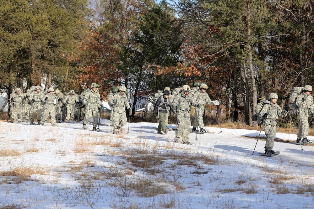 Cold-Weather Operations Course Class 18-05 students practice snowshoeing at Fort McCoy