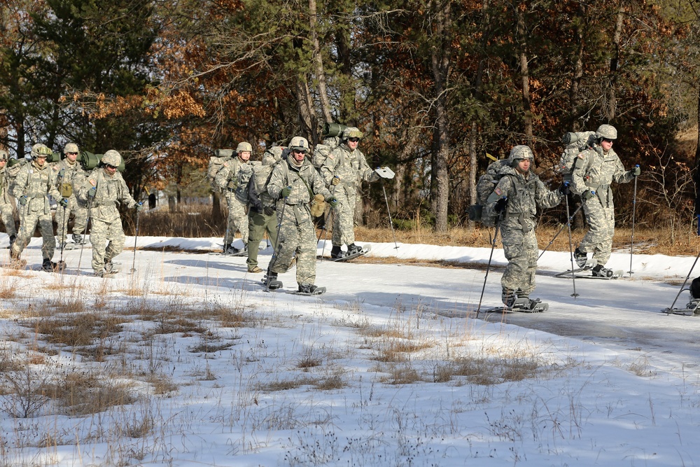 Cold-Weather Operations Course Class 18-05 students practice snowshoeing at Fort McCoy