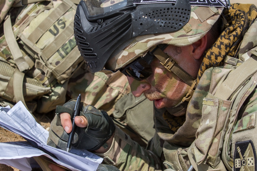 Artilleryman checks map to find the location of an informant