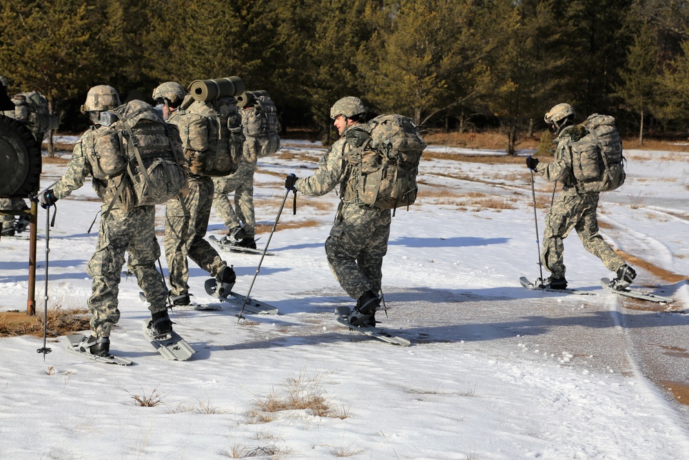 Cold-Weather Operations Course Class 18-05 students practice snowshoeing at Fort McCoy