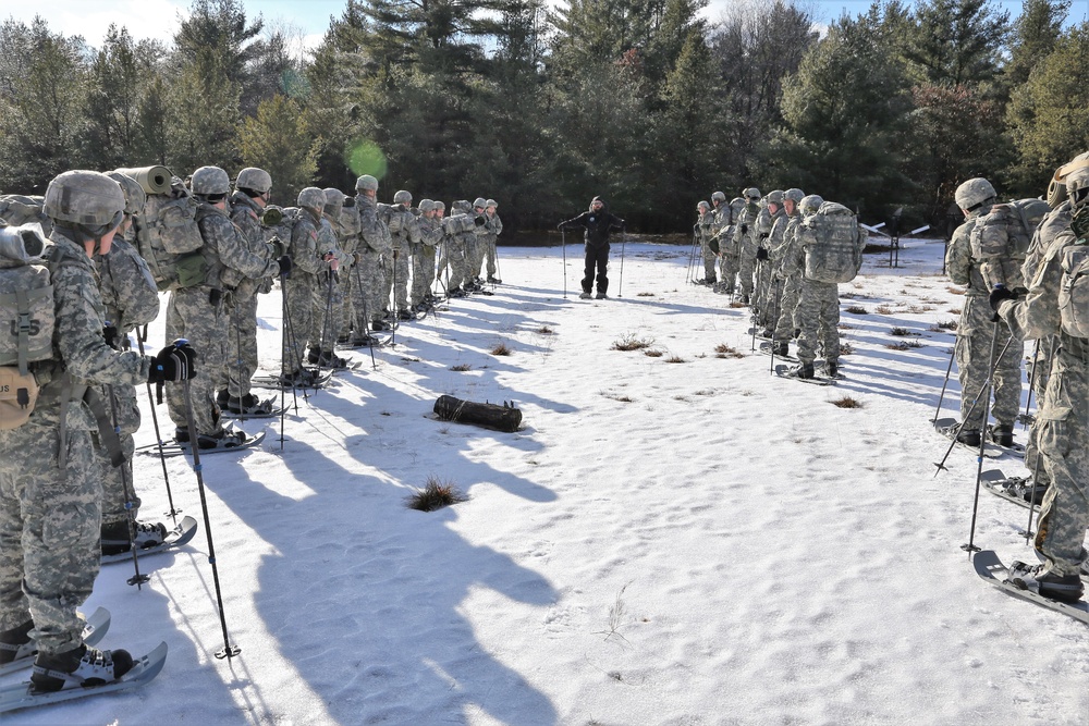 Cold-Weather Operations Course Class 18-05 students practice snowshoeing at Fort McCoy