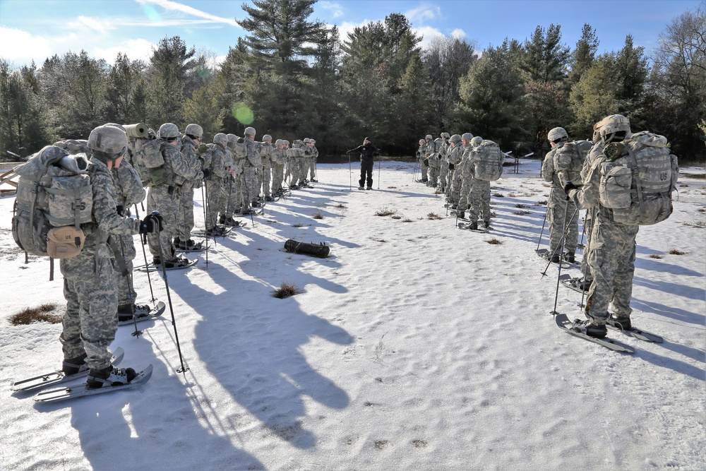 Cold-Weather Operations Course Class 18-05 students practice snowshoeing at Fort McCoy