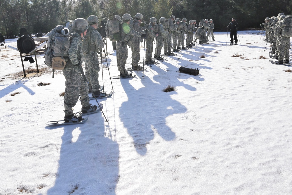 Cold-Weather Operations Course Class 18-05 students practice snowshoeing at Fort McCoy