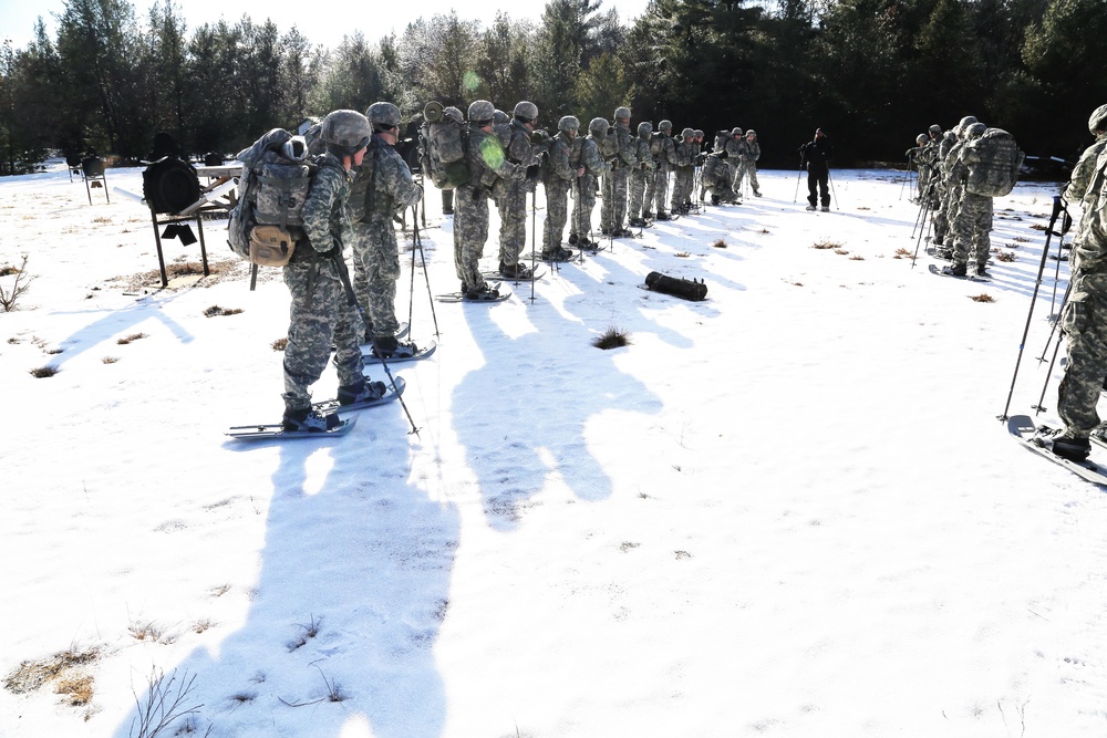 Cold-Weather Operations Course Class 18-05 students practice snowshoeing at Fort McCoy