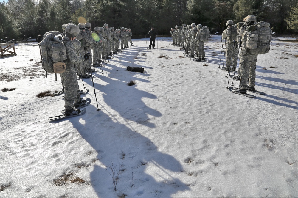 Cold-Weather Operations Course Class 18-05 students practice snowshoeing at Fort McCoy