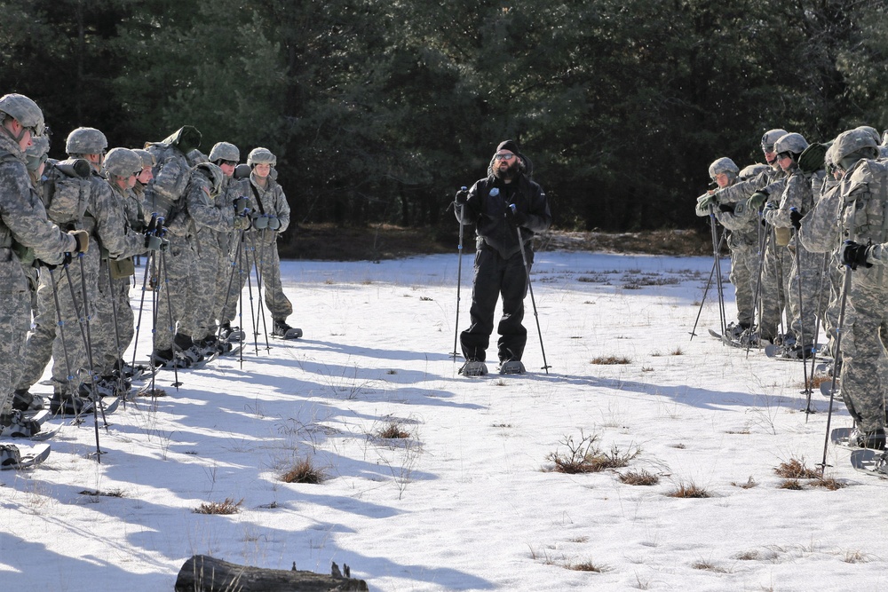 Cold-Weather Operations Course Class 18-05 students practice snowshoeing at Fort McCoy